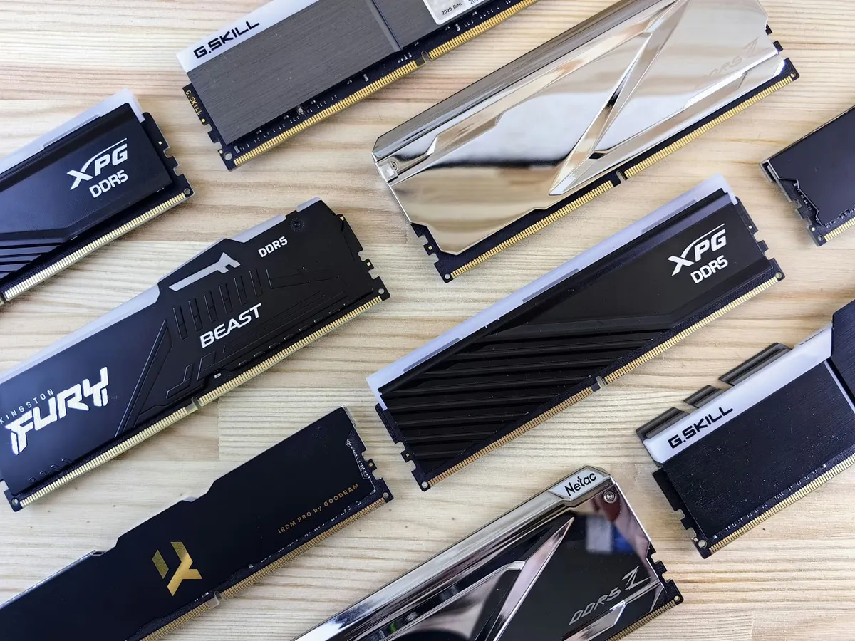 Assorted DDR5 memory modules arranged on a wooden surface